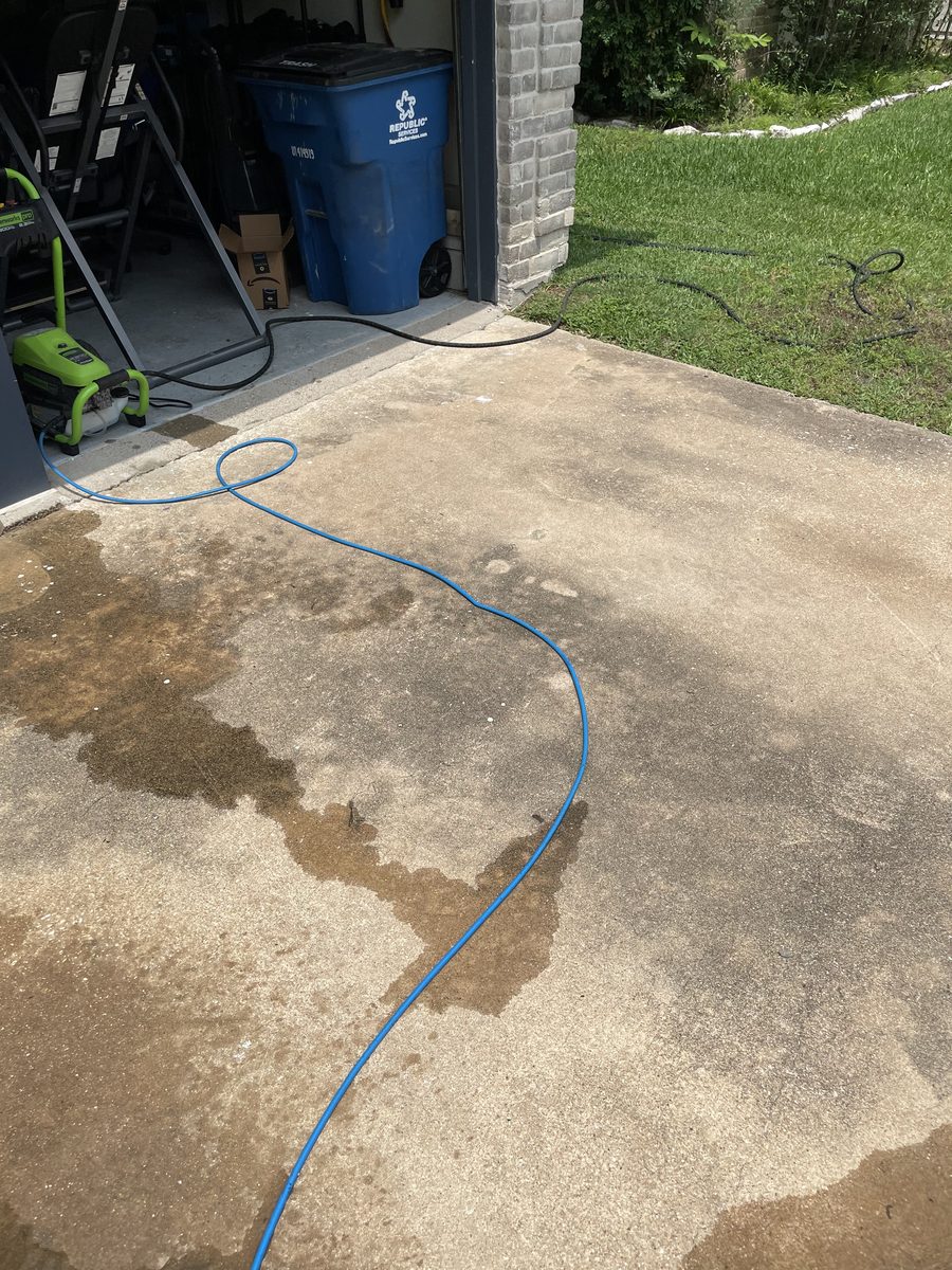 Driveway before power washing — dirty stained concrete